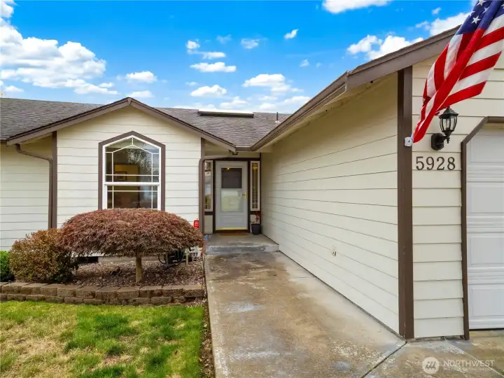 Protected private entrance leads in to this charming home.