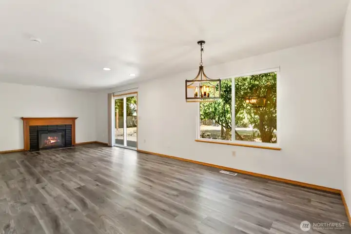 Family/dining room with electric fireplace & sliding glass door access to backyard and patio