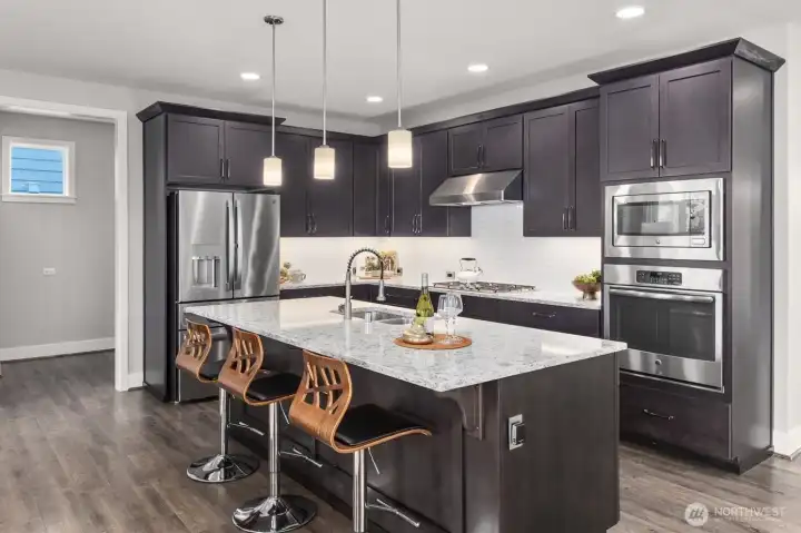 Modern kitchen with stainless steel appliance, USB outlets, built in speakers and more!
