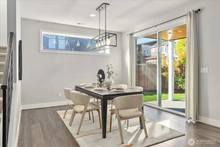 Dining room meets the covered patio through large sliding door.
