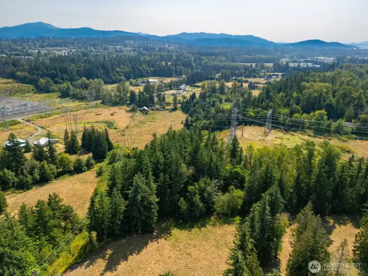 This aerial looks south and east back at the property from the vicinity of the north east corner of the land. The power lines on the left side of this photo are on a road right of way that is also the property line.