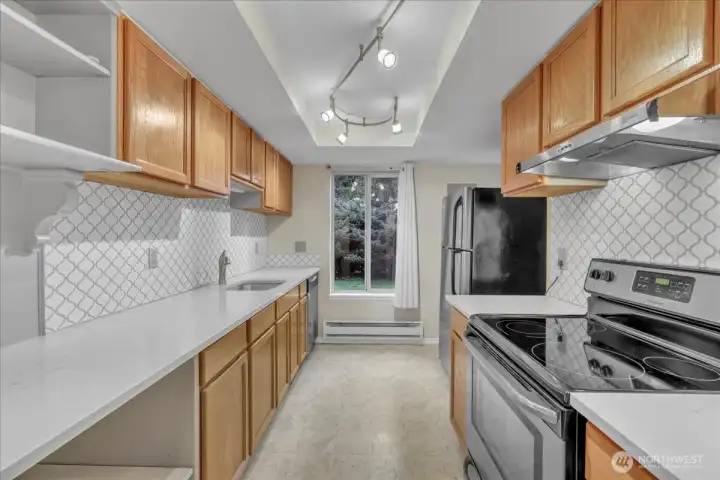 Kitchen with Maple cabinetry, Granite Counters with drop in sink. Frigidaire stainless appliances, Trek lighting and more!