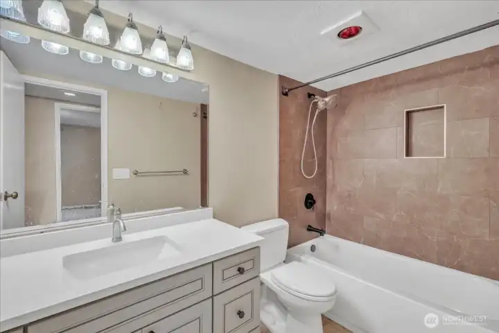Full Bathroom J&K soft close cabinets, granite counters into newer sink. Notice the tiled surround with a niche around tub!