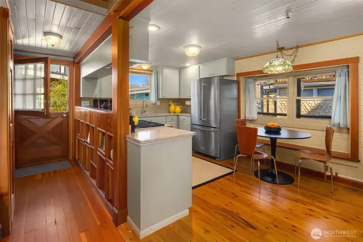 The entry foyer with its charming pass-through and Dutch door sets the tone the moment you step inside, opening naturally toward the kitchen and main living areas.