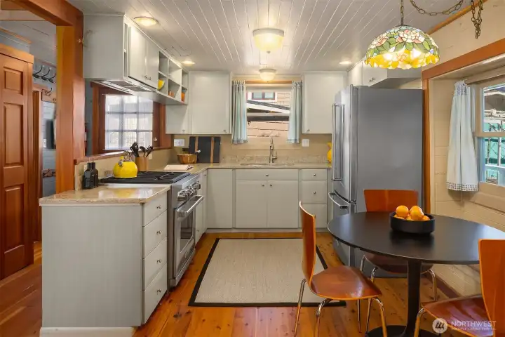 A professional gas range and thoughtfully designed cabinetry make this kitchen a genuine cook's space, with the dining nook just steps away for easy entertaining.