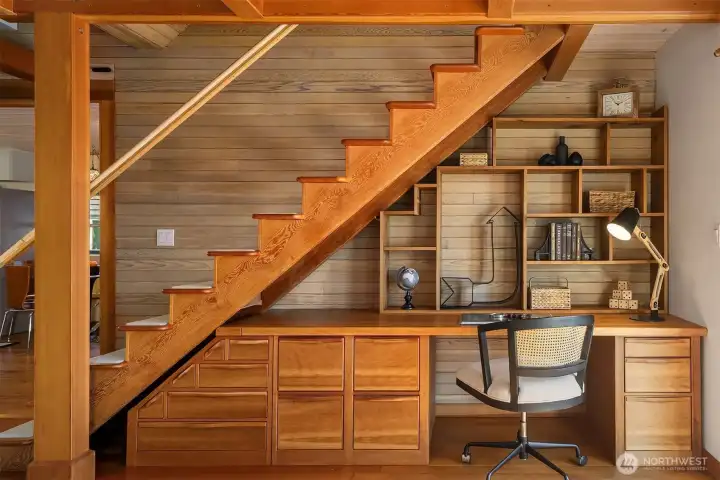 A closer look at the under-stair workspace reveals the craftsmanship in every detail: solid wood, hand-crafted drawers, open shelving, and a desk surface sized for real work.
