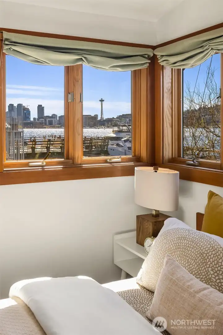 Wake up to this. The Space Needle and Seattle skyline fill the corner windows of the primary bedroom, a view that never gets old.
