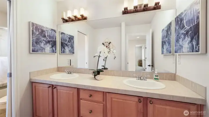 Beautiful guest bath featuring a pocket door for a private water closet.