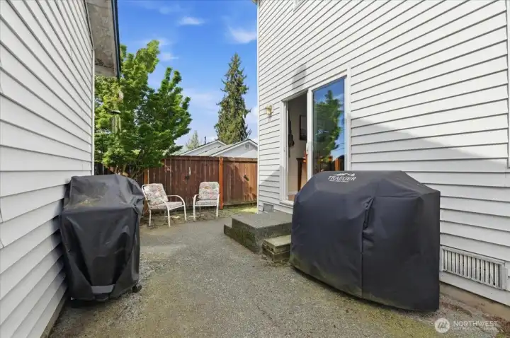Patio area between the home and detached garage