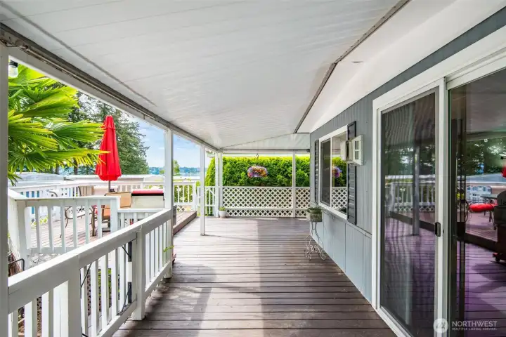 Sliding glass door access creates an easy indoor-outdoor connection to the expansive covered wrap-around deck and peaceful coastal setting. Sliding glass door access creates an easy indoor-outdoor connection to the expansive covered wrap-around deck and peaceful coastal setting.