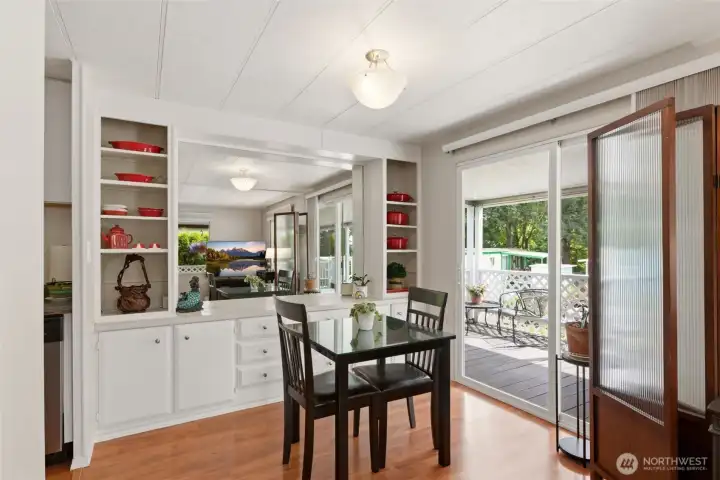 Dining area with built-in credenza and sliding glass door access creates the perfect setting for morning coffee before stepping out to the deck and Puget Sound views. Dining area with built-in credenza and sliding glass door access creates the perfect setting for morning coffee before stepping out to the deck and Puget Sound views.