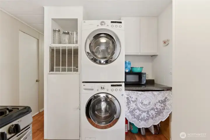 Dedicated laundry space with stackable front-load washer and dryer keeps daily living simple, organized, and efficient. Dedicated laundry space with stackable front-load washer and dryer keeps daily living simple, organized, and efficient.