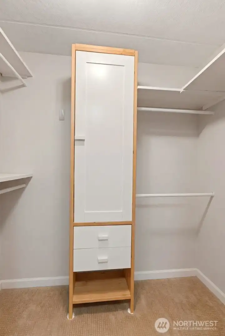 Generous walk-in closet with built-in shelving provides organized storage space for clothing, shoes, and everyday essentials. Generous walk-in closet with built-in shelving provides organized storage space for clothing, shoes, and everyday essentials.
