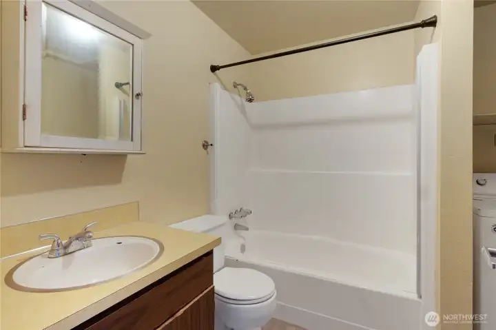 Full bath with blended laundry area.