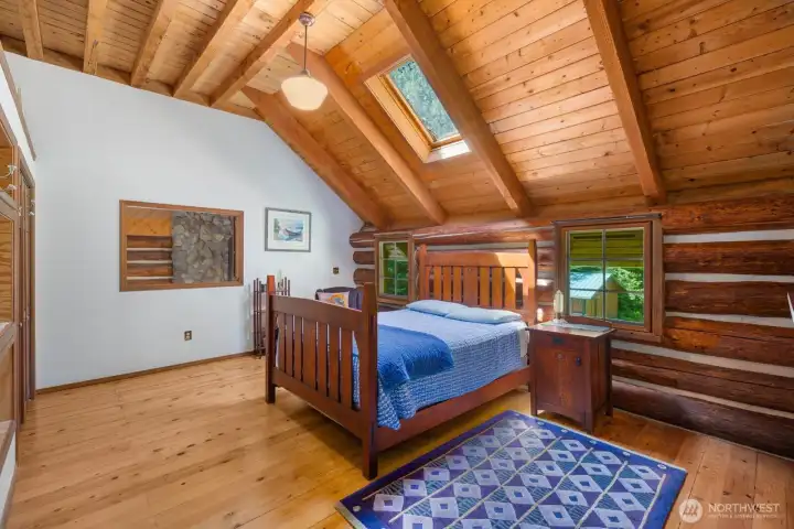Spacious primary bedroom with a view down to the main floor below. Spacious primary bedroom with a view down to the main floor below.