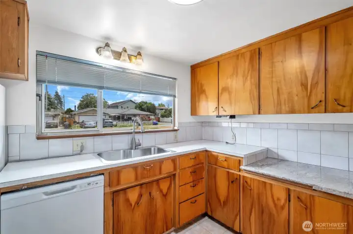 Kitchen window looks onto the front yard.