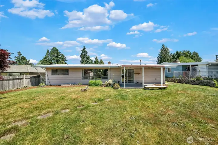 Large backyard that looks onto the open space.