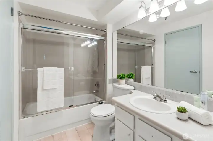 Full bathroom with newer toilet, newer plumbing and light fixtures and newer laminate hardwood flooring. Full bathroom with newer toilet, newer plumbing and light fixtures and newer laminate hardwood flooring.