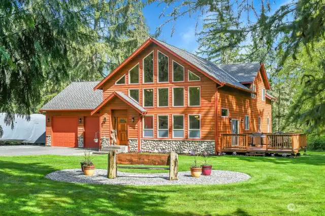 Beautiful custom home surrounded by 5 acres of private park-like setting.