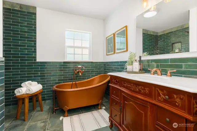 Beautiful sink, fixtures, tile work and a copper tub