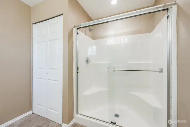 Spacious walk-in shower is ideal for comfort and convenience.