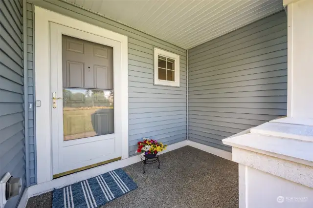 Charming, covered front porch, perfect for enjoying morning coffee.