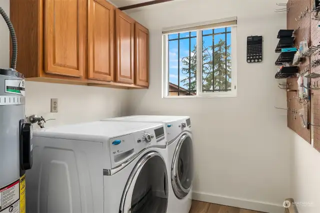 The practical utility room is located off the garage and features frontload washer and dryer and functional and efficient storage.