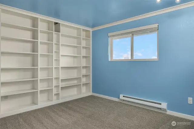 This guest room could also function as a home office with lots of space for books and knick-knacks.