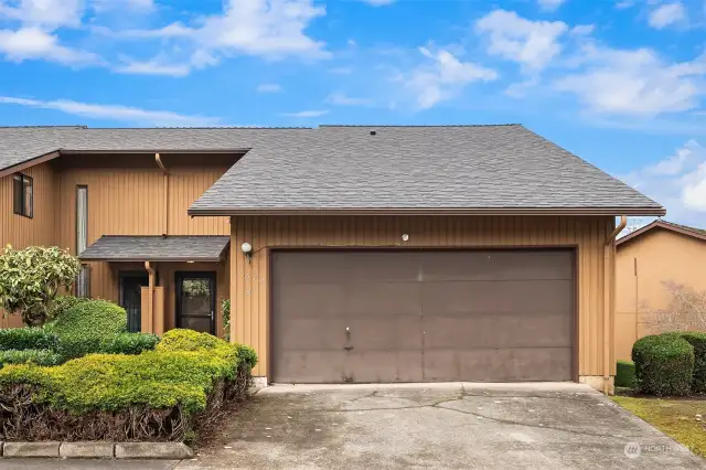 Another view of the front exterior featuring the double garage and private driveway.