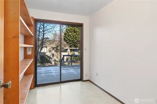 Bonus room has built-in shelving and sliding doors to the deck.