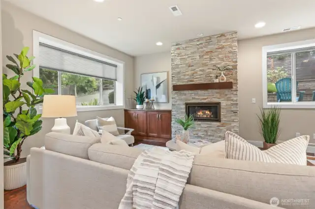 Fire place framed by floor to ceiling stone.  Top-down, bottom-up shades in all rooms.