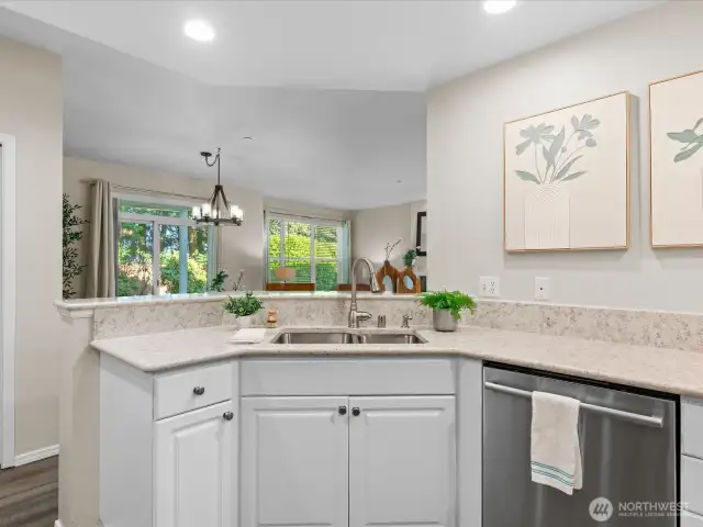 Kitche bar overlooks main living area with views of the lush backyard.
