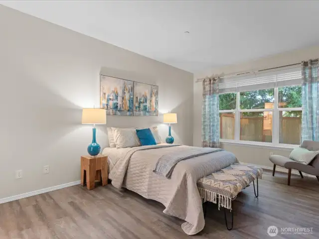 Spacious Primary Bedroom with window looking out to private backyard