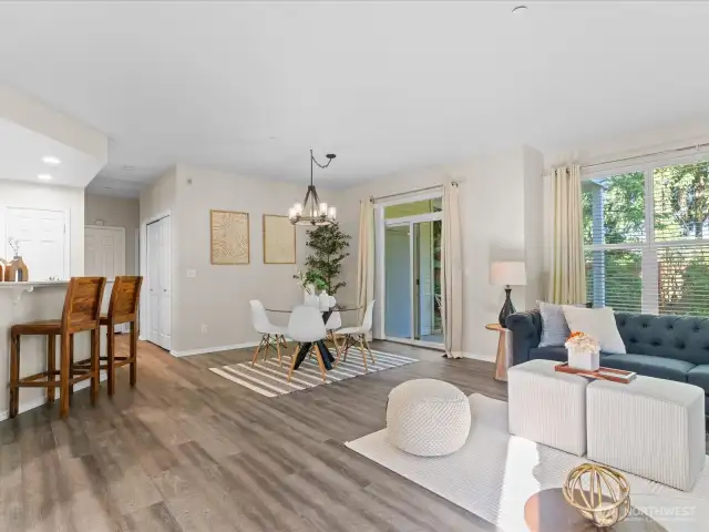 Upon entering the unit, you step into a light and bright open floor plan with living room, kitchen, dining area and a walk out sliding door to your very own private back yard.