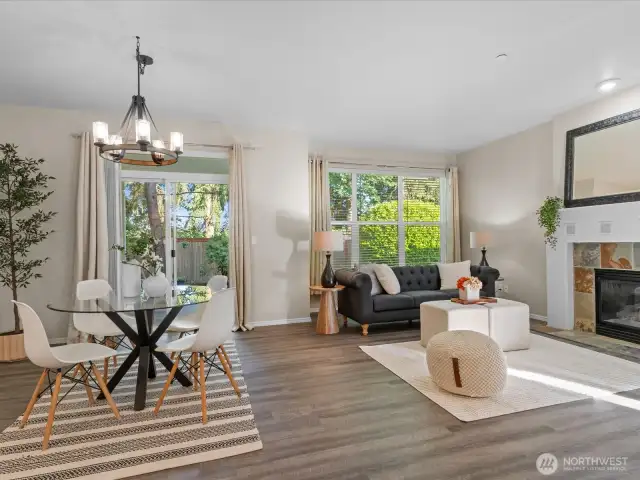 The comfortable dining and living room area with cozy gas fireplace opens to a beautiful fenced back yard.