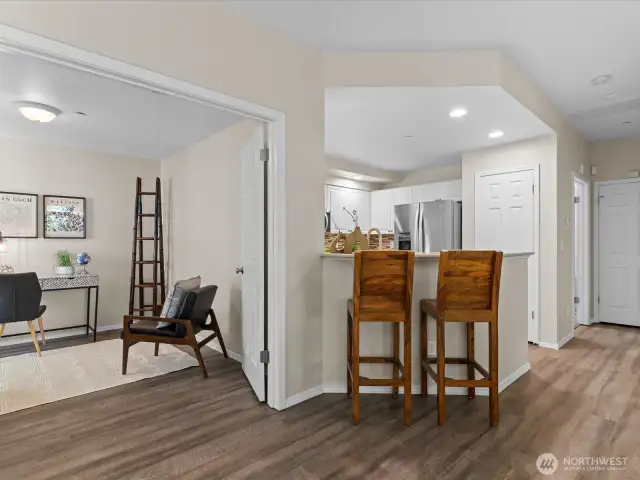 Kitchen opens to main living area with cozy breakfeast bar