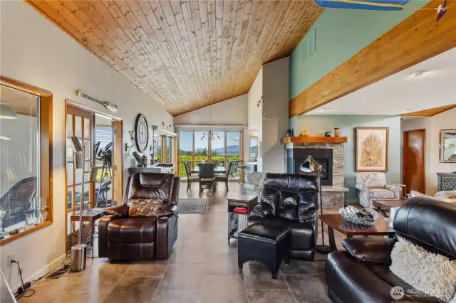 Living, dining and sunroom with beautiful wood ceilings, new windows and decks.