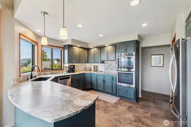 Well designed and planned updated kitchen with leathered granite counters, stainless appliances including refrigerator, double oven and dishwasher. New flooring and windows, even space to enjoy your morning coffee.