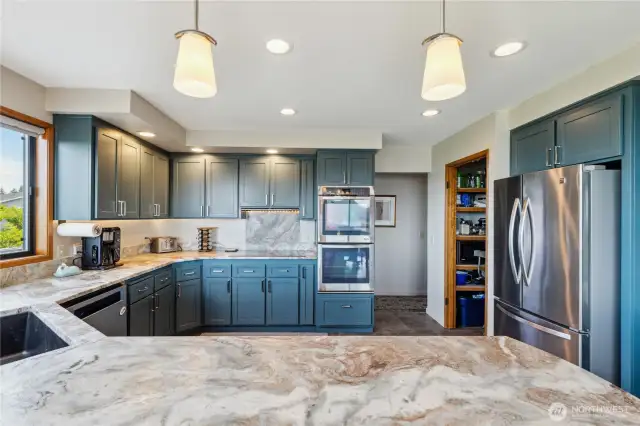 Gorgeous chef's kitchen with leathered granite counters, freshly painted cabinets, stainless appliances, a walk-in pantry for additional storage. There's even a coffee bar to the right (not shown). Enjoy the view as you wash the dishes!!