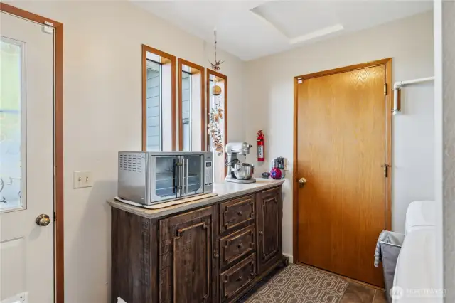 Main level utility room. with doors to garage and dog run.