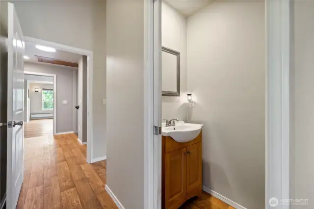 The home features easy-care LVP flooring throughout, a convenient half bath, abundant storage, and plenty of natural light streaming in from numerous windows.