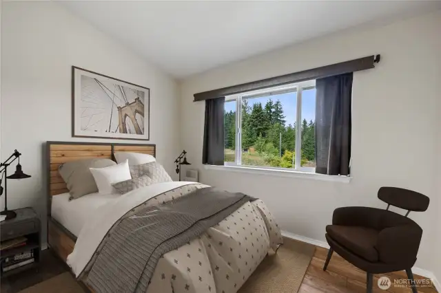 Bedroom #2, located across from the half bath, offers a large closet, a built-in fold-down table, and a lovely view of the beautifully landscaped backyard.