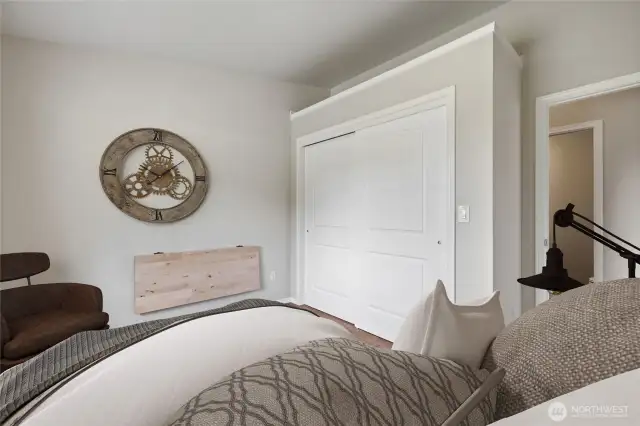 Bedroom #2, located across from the half bath, offers a large closet, a built-in fold-down table, and a lovely view of the beautifully landscaped backyard.