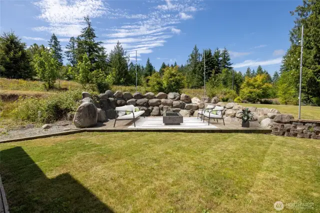 Outdoor patio for endless entertaining! Poles in place for string lights.