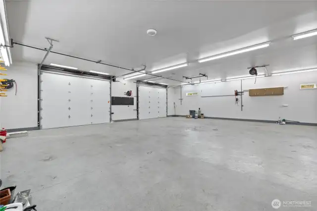The shop is equipped with 200-amp electrical service and two oversized 12' wide by 10' high garage doors for easy access. Extra lighting is installed throughout to ensure a bright, functional workspace. With 23 heavy-duty chain pots integrated into the slab, the space is ideal for auto body work, securing large equipment, or tackling serious fabrication projects.