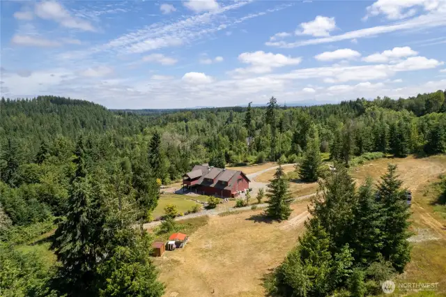 The possibilities are endless with this expansive property. From this vantage point, you can see the custom chicken coop and storage shed, nestled within the landscape. Surrounded by the natural beauty of the forest, the property offers a serene and private retreat that’s perfect for relaxation, recreation, or expansion.