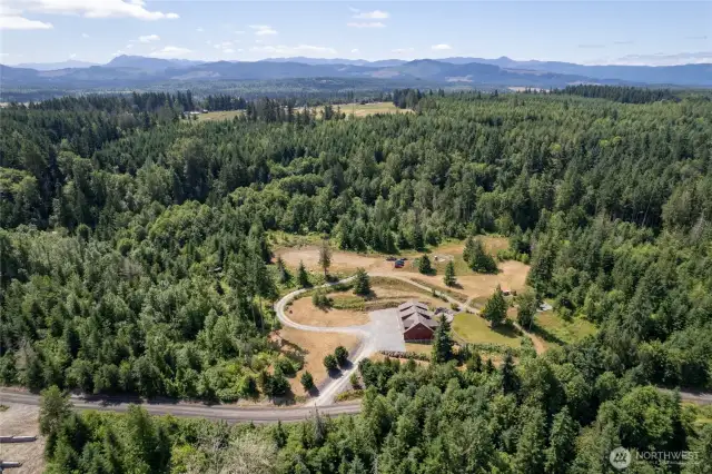 An expansive driveway and ample parking provide plenty of space for vehicles, trailers, and guests.
