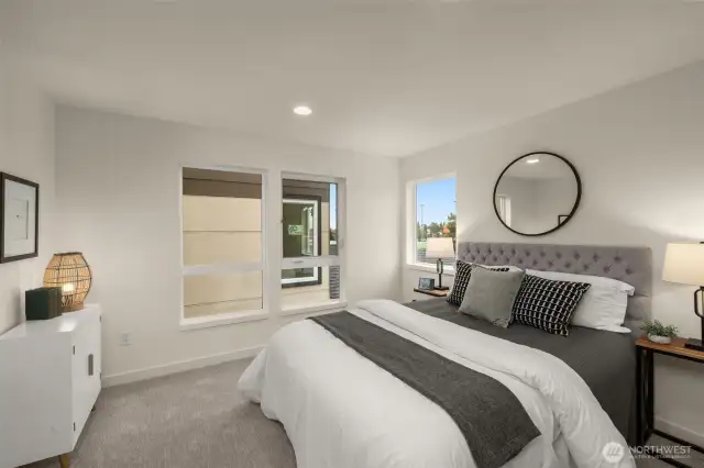 This secondary bedroom is bathed in natural light, creating a serene and welcoming atmosphere. Its neutral tones and spacious layout make it a perfect space to unwind after a busy day. Photos of home with similar layout, finishes & fixtures.