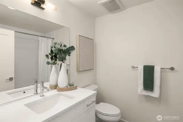 Modern and sleek, this bathroom combines style with functionality. The clean design, complemented by elegant lighting and a spacious vanity, makes it ideal for morning routines and evening relaxation. Photos of home with similar layout, finishes & fixtures.