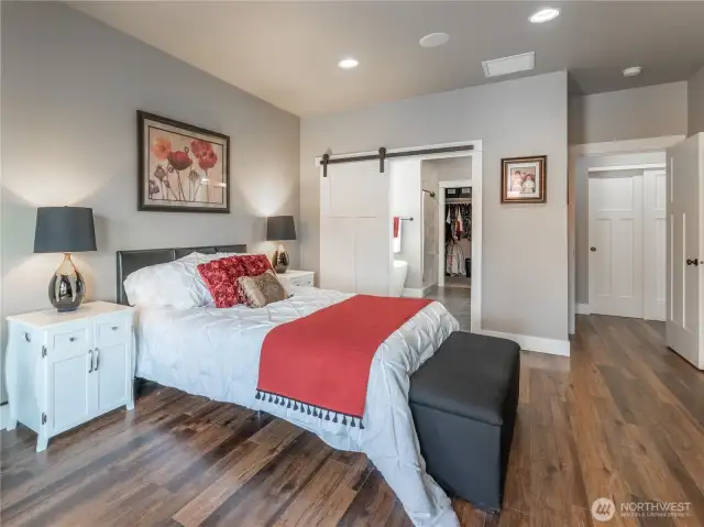 Barn door to primary bathroom